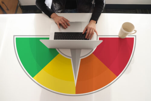 Woman using laptop with credit score on laptop screen