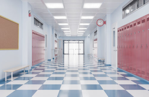 A school hallway featuring rows of red lockers,