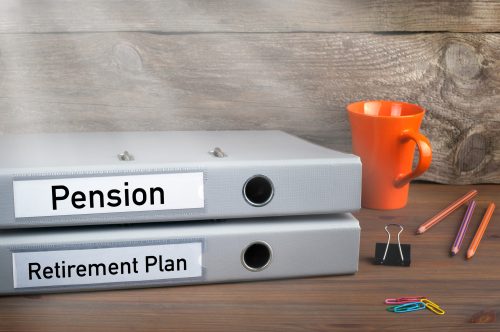 Retirement Plan and Pension – two folders on wooden office desk