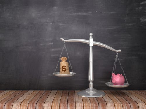 Scales of Justice with Piggy Bank and Dollar Sack on Wood Floor – Chalkboard Background – 3D Rendering