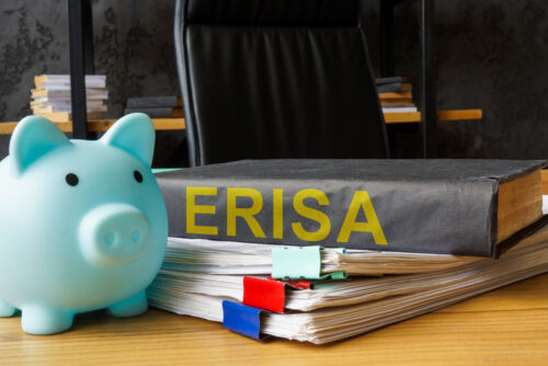 ERISA book and piggy bank. Retirement savings.