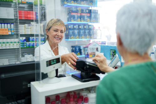 woman spending money at store