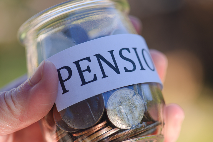 person holding a jar with money and word pension is on the jar.