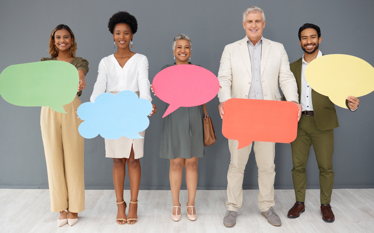 Group of people standing with speech bubbles representing diverse thoughts and opinions. 